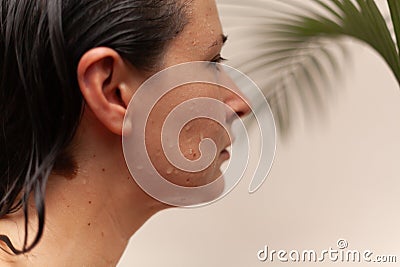 Profile of beautiful woman with water drops on her face Stock Photo