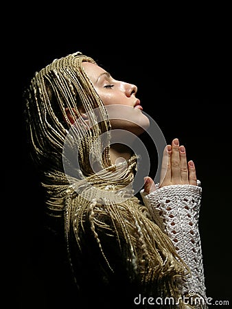 Profile close up of a young praying girl Stock Photo