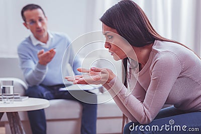 Profile of dispirited young woman visiting psychologist Stock Photo