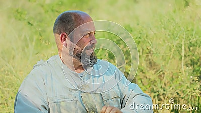 Profile of a distracted beekeeper on a field Stock Photo