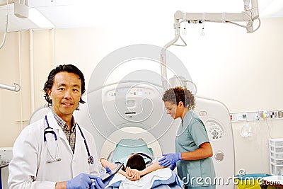 Profile of Doctor with CAT scanner Stock Photo