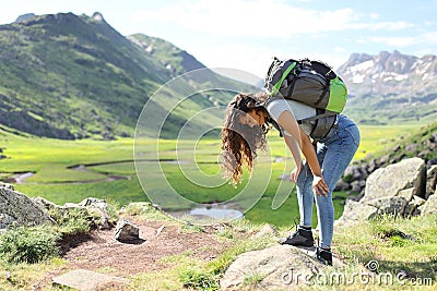 Exhausted hiker resting after climbing a mountain Stock Photo