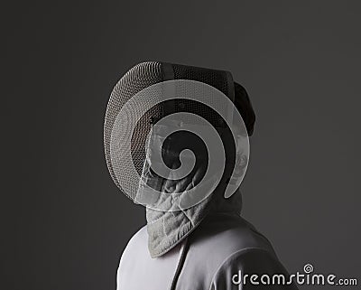 Profile of a fencer in fencing mask Stock Photo