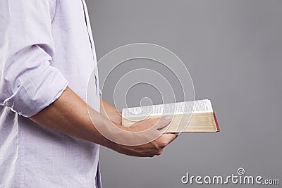 Profile of Hands holding Bible Stock Photo