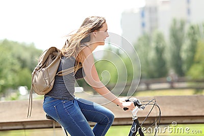 Profile of a happy woman on a bicycle Stock Photo