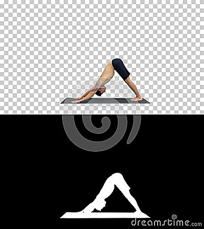 Profile of muscular handsome young man working out, standing in yoga upward, downward facing dog pose, then streching Stock Photo