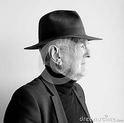 Profile of older man in black hat Stock Photo