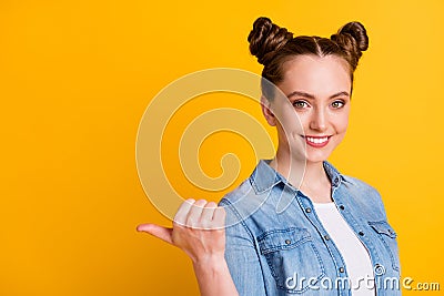 Profile photo of charming attractive teen lady two buns direct thumb finger side empty space show shopping offer Stock Photo