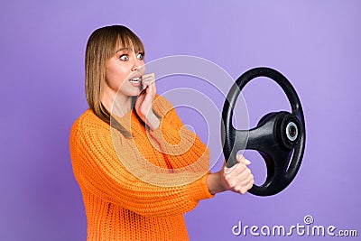 Profile photo of scared lady driver hold steering wheel bite nail wear orange jumper purple color background Stock Photo