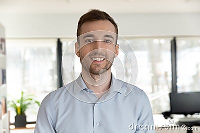 Profile picture of Caucasian male employee posing in office Stock Photo