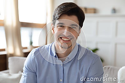 Profile picture of young handsome man sitting on sofa. Stock Photo