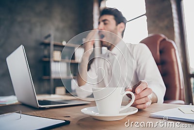 Profile side low angle view photo of tired middle eastern marketer man have lots work yawn want sleep take mug with hot Stock Photo