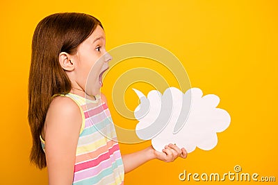 Profile side photo of cute child holding paper card bubble shouting yelling isolated over yellow background Stock Photo