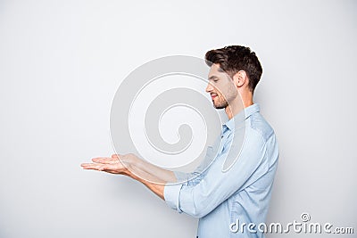 Profile side photo of focused man hold hand present ads promo in his palms real promoter wear casual style isolated over Stock Photo