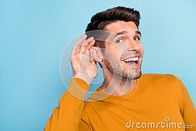 Profile side photo of young cheerful man happy positive smile eavesdrop listen gossip isolated over blue color Stock Photo