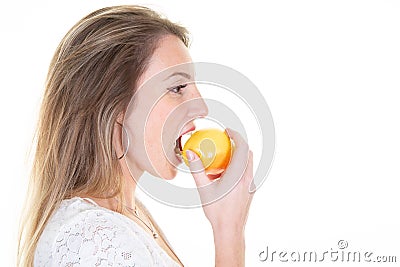 Profile side portrait of beauty cheerful young blonde woman eating red yellow apple Stock Photo