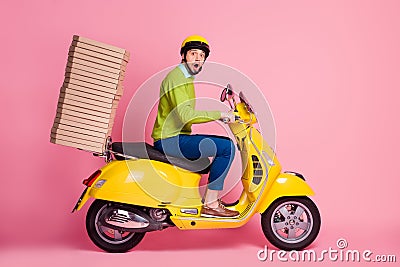 Profile side view of his he nice attractive funky worried busy guy driving moped bringing carrying pile stack pizza cafe Stock Photo