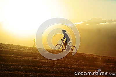 Profile silhouette sport man cycling uphilll riding cross country mountain bike Stock Photo