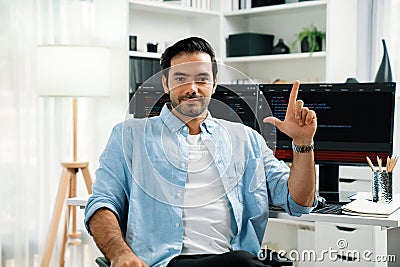 Profile smart IT developer looking camera against on coding pc screen. Surmise. Stock Photo