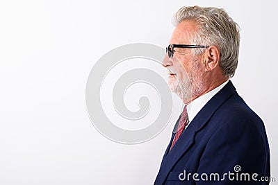 Profile view of happy senior bearded businessman smiling while w Stock Photo