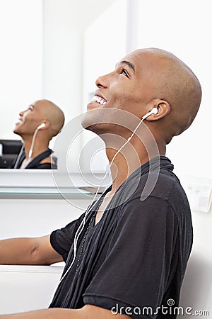 Profile view of man listening music at salon Stock Photo