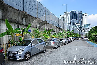 Profile view of the Saloma link bridge with a local pedestrian walking and crossing it Editorial Stock Photo