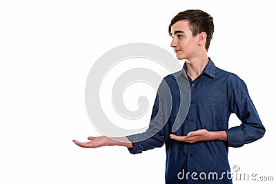 Profile view of young handsome Persian teenage boy showing somet Stock Photo