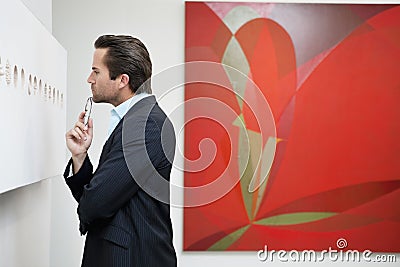 Profile view of a young man in a art art gallery Stock Photo