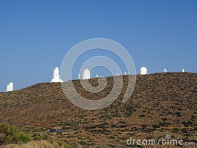 Profile of white telescopes under blue sky. Teide Astrophysical Observatory. Observational set of the Institute of Astrophysics. Stock Photo