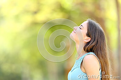 Profile of a woman breathing fresh air in a forest Stock Photo