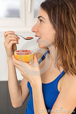 Profile of woman eating fruit Stock Photo