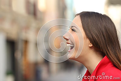Profile of a woman face laughing happy in the street Stock Photo