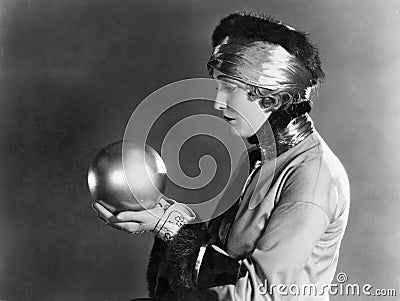 Profile of a woman holding a metal ball Stock Photo