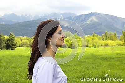 Profile of young woman with eyes closed breathing fresh air in the mountains Stock Photo