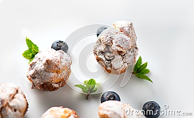 Profiterole or cream puff with filling, powdered with sugar, with berries, isolated on white background Stock Photo