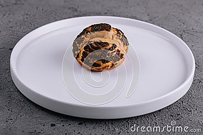 A profiterole, french choux pastry covered chocolate chips Stock Photo