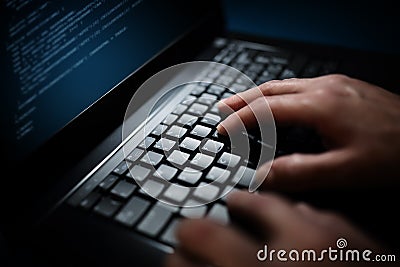 Programmer or computer hacker typing on laptop keyboard Stock Photo