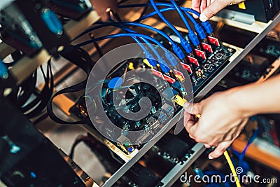 Programmer configures hardware for mining Stock Photo