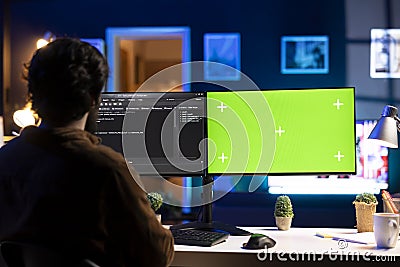 Programmer doing software debugging on green screen PC at home Stock Photo