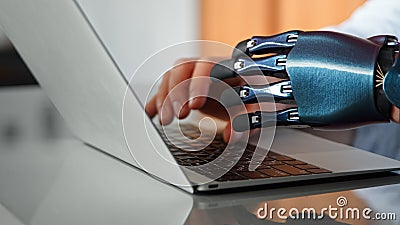 Programmer man hands with artificial bio prothesis type on laptop keyboard on table under bright sunlight Stock Photo