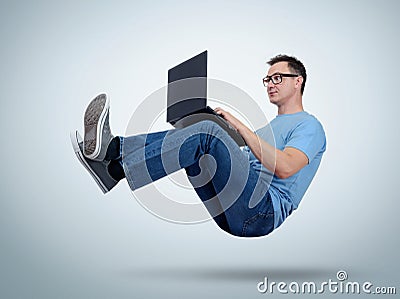 Programmer man working with laptop in the air. Unreal concept Stock Photo