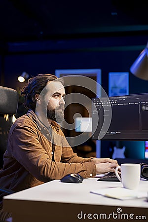 Programmer typing on keyboard, installing fortified code on PC Stock Photo