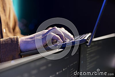 Programmer typing on laptop to fix system vulnerabilities, close up Stock Photo