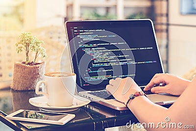 A programmer typing source codes in a coffee shop. Studying, Working, Technology, Freelance Work, Web Design Business concepts. Stock Photo