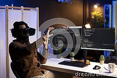 Programmer using high tech VR headset to secure company servers from virus Stock Photo