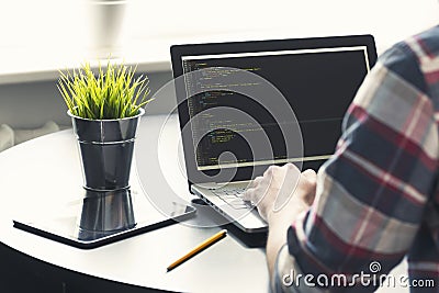 Programmer working on laptop at office Stock Photo