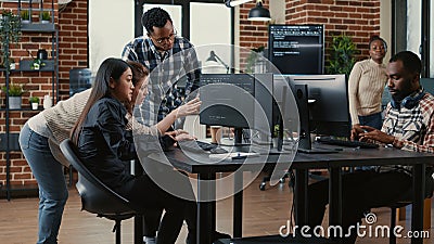 Programmers collaborating on group project compiling algorithm for new cloud computing user interface Stock Photo