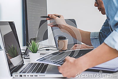 Programmers cooperating at Developing programming and website working in a software develop company office, writing codes and Stock Photo