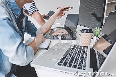 Programmers cooperating at Developing programming and website working in a software develop company office, writing codes and Stock Photo