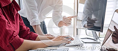 Programmers cooperating at Developing programming and website working in a software develop company office, writing codes and Stock Photo